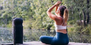 girl meditating by river