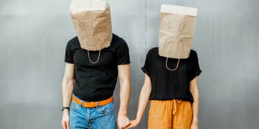 Couple with sage bags on their heads