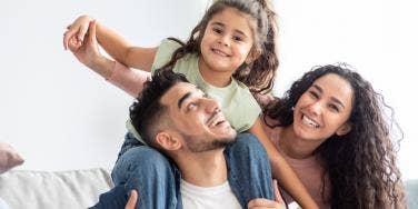 parents playing with daughter