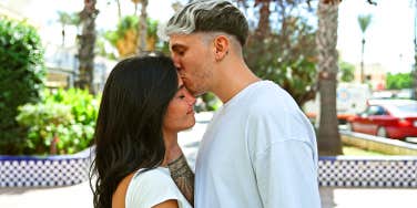 guy kissing girl's forehead
