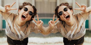 Young woman excited peace sign