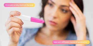 woman holding pregnancy test