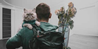 Man holding a cat with a backpack