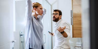 man and woman couple arguing in the bathroom