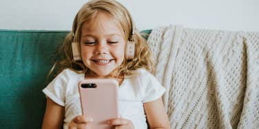 girl on headphones looking at ipad