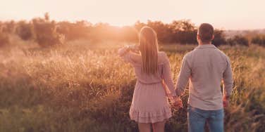 couple holding hands in the wild