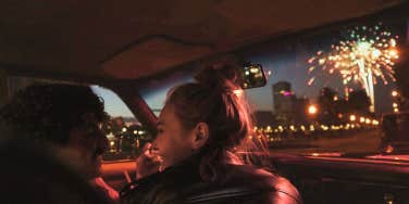 Couple in car watching fireworks 