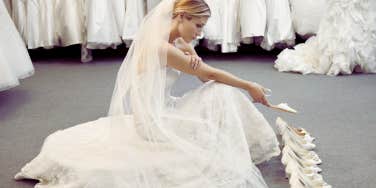 sad woman trying on wedding dresses