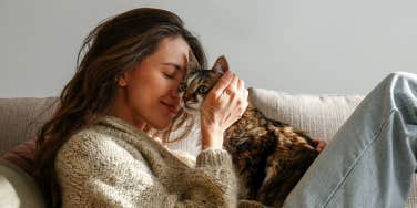 woman hugging cat