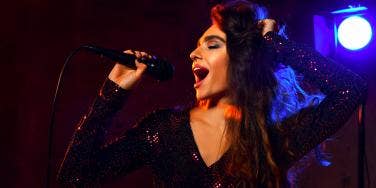 woman singing on a microphone