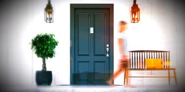 ghostly image woman walking in front of the house