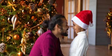 dad smiles at his son on christmas