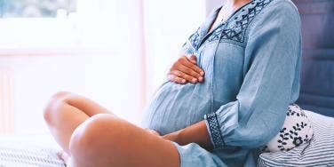 pregnant woman holding belly