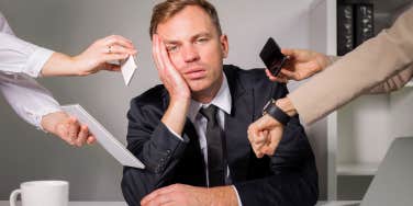 Man looking burnt out and stressed while at work