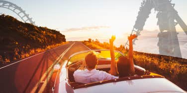 Couple driving on a road roller coaster in background