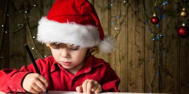 little boy writing letter to santa