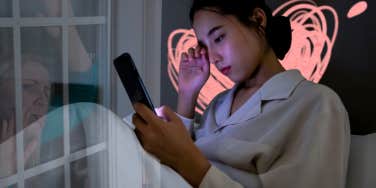 WOman sad on phone in bed