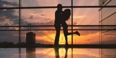 couple hugging in airport