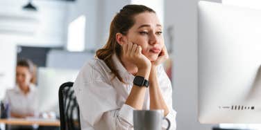 bored woman staring at her computer