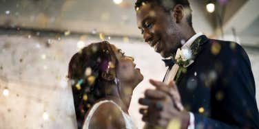 man and woman standing at altar