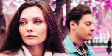 woman looking away from man offended he said love you instead of I love you