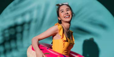 woman in pool floaty smiling