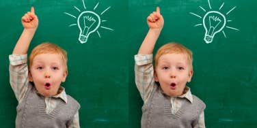 Cheerful smiling child at the blackboard