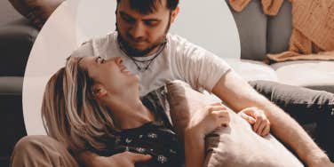 Couple on the floor, woman laying in his lap