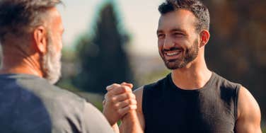 two men in running clothes sharing a high five