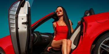 woman in red sports car