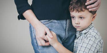 sad son hugging his mother at home.