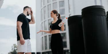 man and woman arguing at the gym