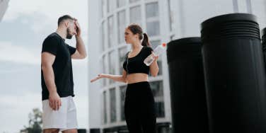 man and woman arguing at the gym