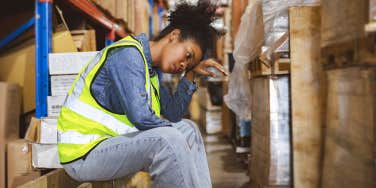 tired stressed woman sitting at her labor job