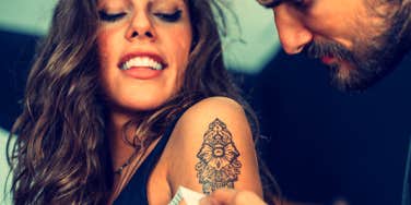 woman getting a mandala tattoo