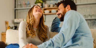 happy couple sitting on couch