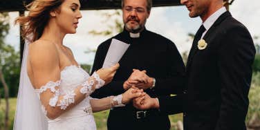 couple getting married reading vows