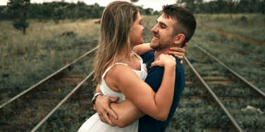 happy couple on train tracks