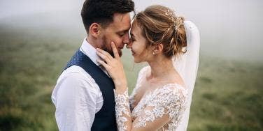 man and woman embracing faces on wedding day