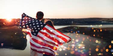 couple standing with American flag