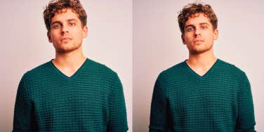 man wearing green sweater looking at the camera