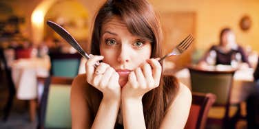 woman holding fork and knife