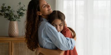 mother hugging her teenage daughter