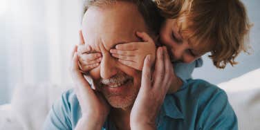 young child playing with grandfather