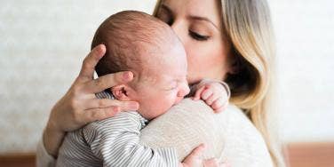 woman cradling baby