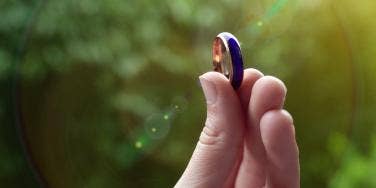 person holding up a mood ring