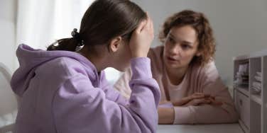 mother scolding upset teenage daughter