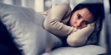 woman crying alone on couch