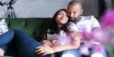 woman and man cuddling on couch