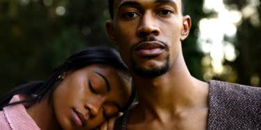 girlfriend resting her head on her boyfriend's shoulder